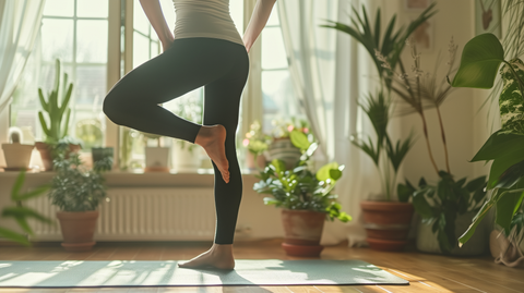 person standing on one leg in a living room