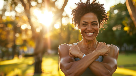 a muscular woman at the park flexing her arms