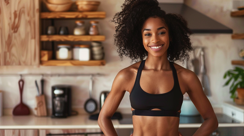 an in-shape young lady with defined abs standing in the kitchen